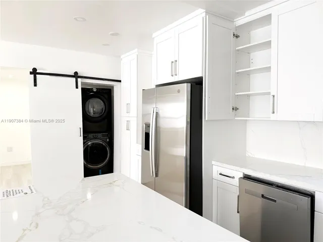 a kitchen with a refrigerator and a sink