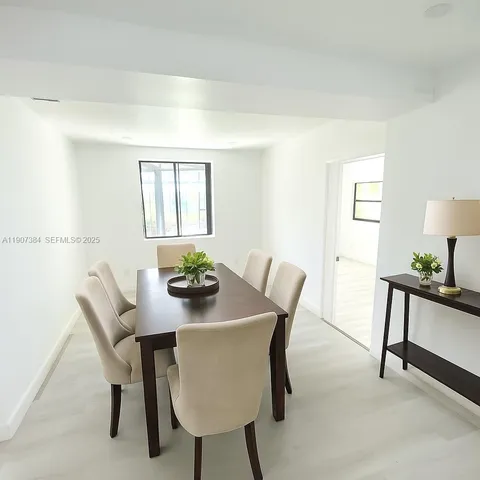 a view of a dining room with furniture and window