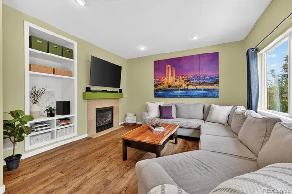 a living room with furniture fireplace and flat screen tv