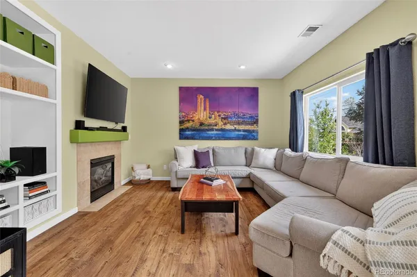 a living room with fireplace furniture and a flat screen tv
