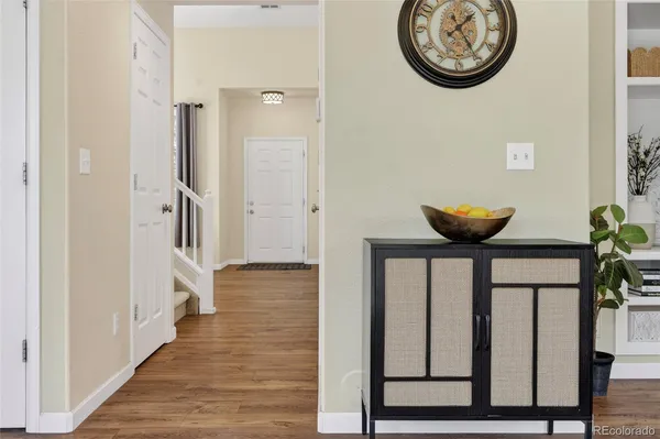 a view of a hallway with wooden floor
