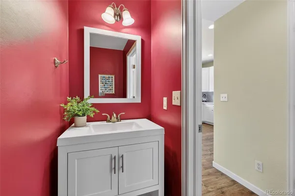 a bathroom with a sink vanity and a mirror