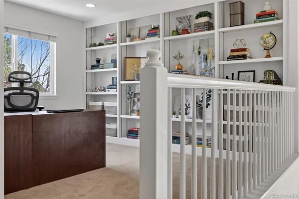 a room with furniture a refrigerator and a window