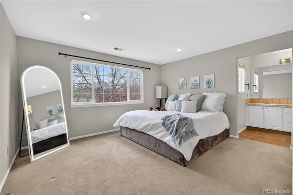 a spacious bedroom with a bed and a large window