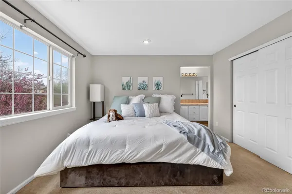 a bedroom with a bed and glass window