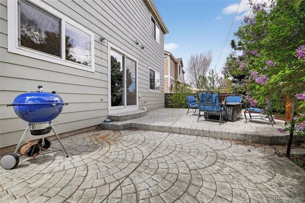 a view of a chairs and table in the backyard