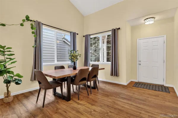 a view of a dining room with furniture window and wooden floor