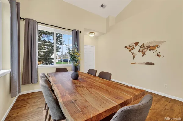 a view of a dining room with furniture and wooden floor