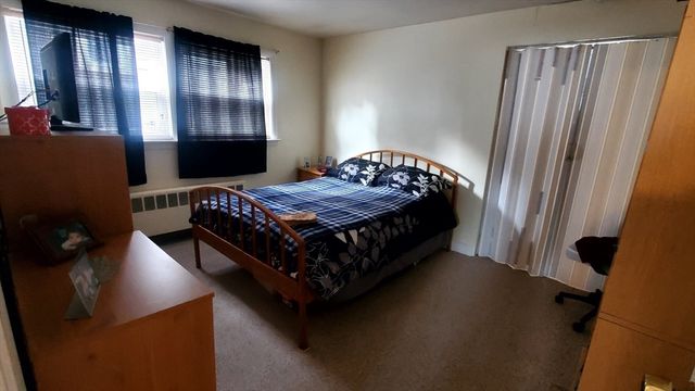 a bedroom with a bed and cabinets