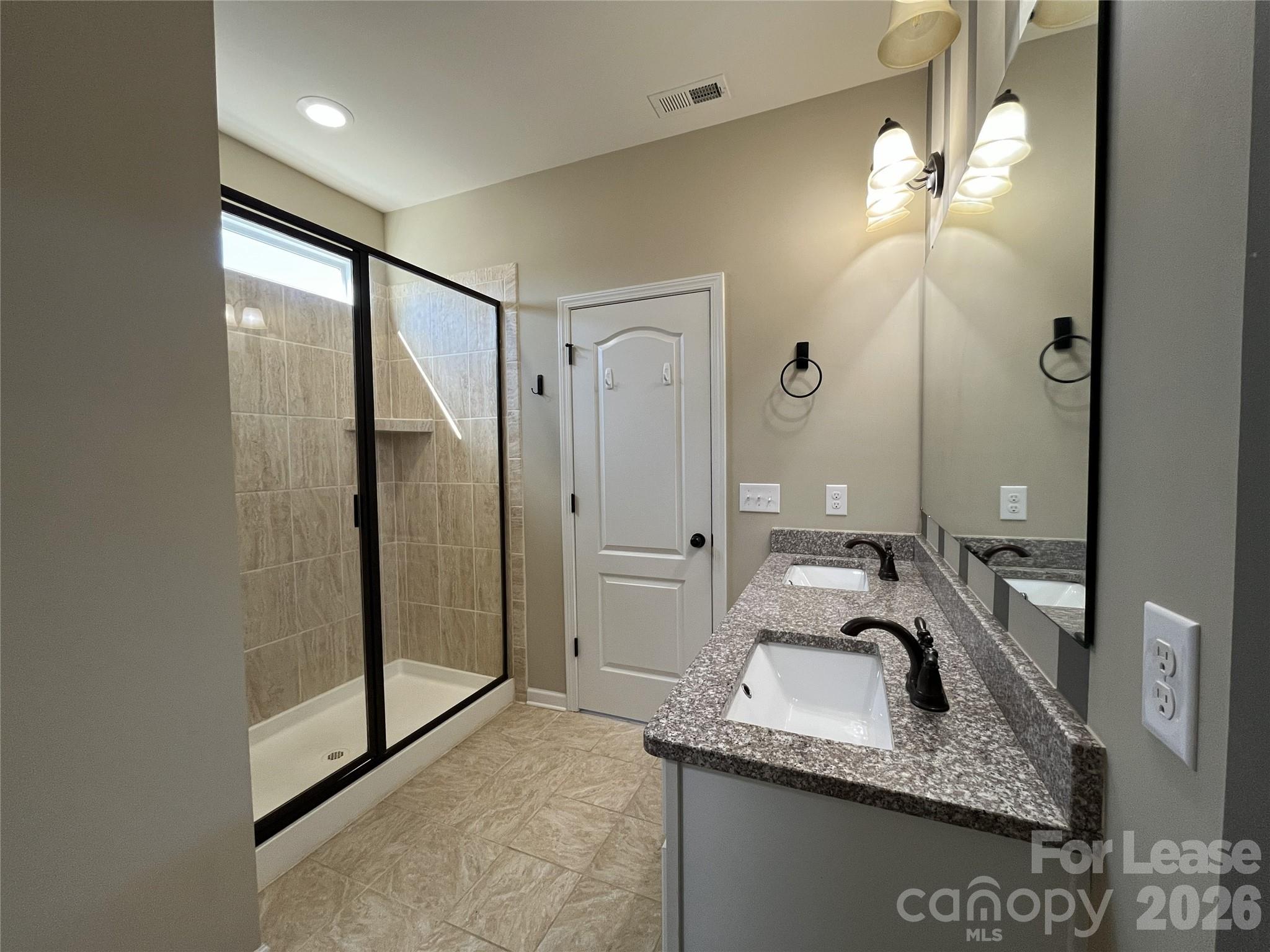 105 East Neel Ranch Road Mooresville, NC 28115 - Photo 12 of 27 a bathroom with a granite countertop sink a mirror and a shower