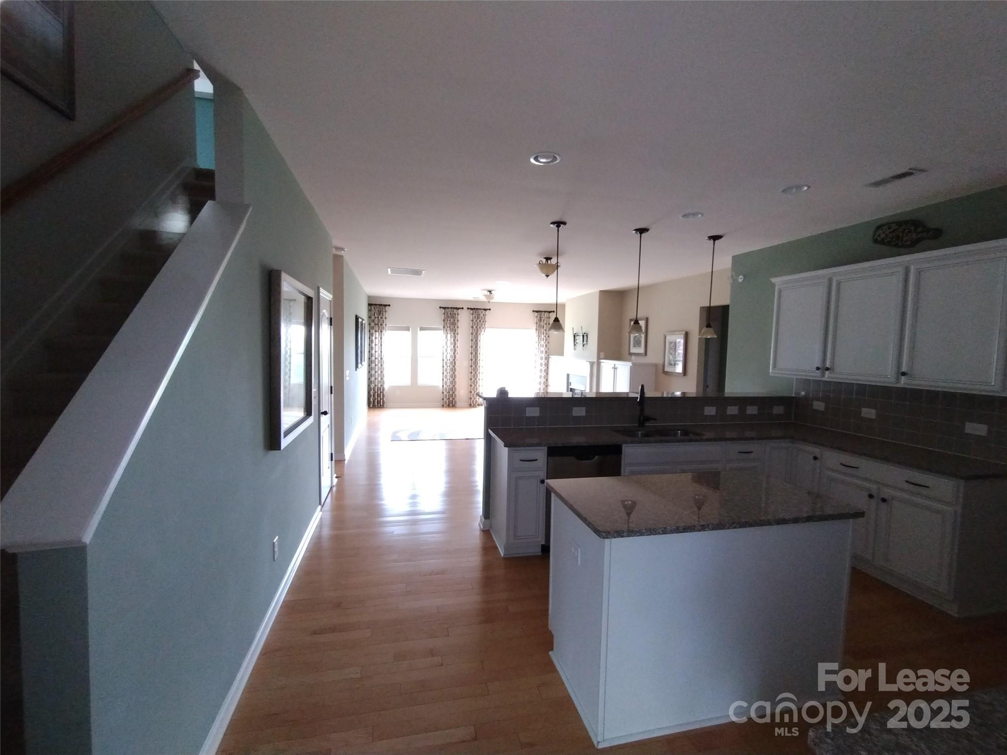 105 East Neel Ranch Road Mooresville, NC 28115 - Photo 13 of 23 a kitchen with kitchen island stainless steel appliances a sink stove and cabinets
