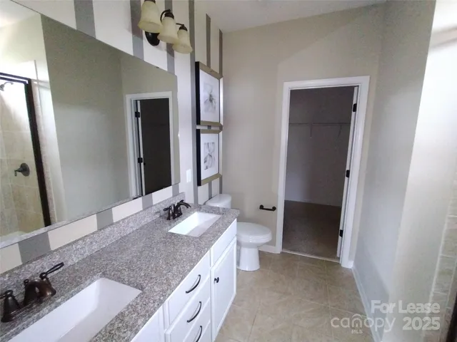 a bathroom with a glass shower door