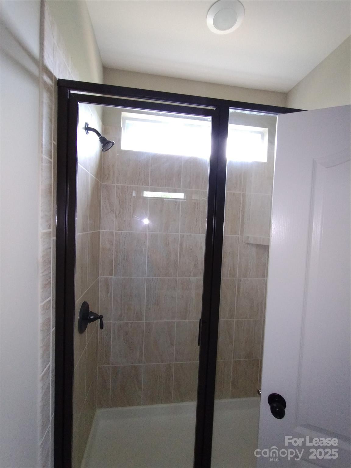 105 East Neel Ranch Road Mooresville, NC 28115 - Photo 17 of 23 a bathroom with a glass shower door