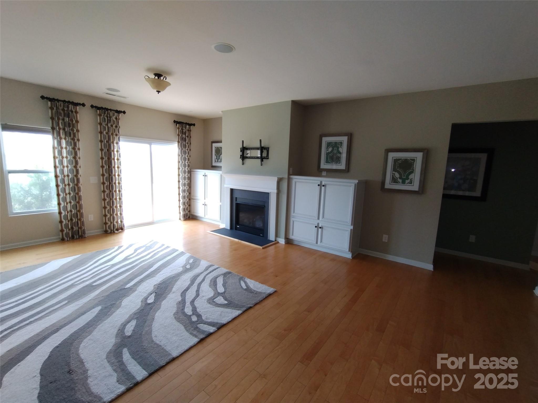105 East Neel Ranch Road Mooresville, NC 28115 - Photo 21 of 23 a view of empty room with wooden floor and fireplace