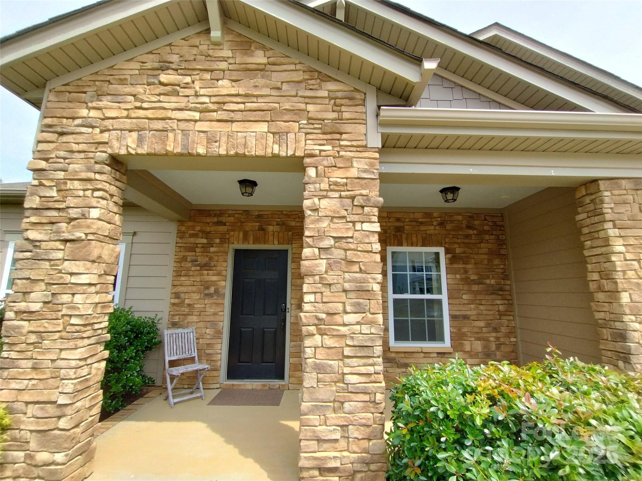 105 East Neel Ranch Road Mooresville, NC 28115 - Photo 3 of 23 a front view of a house with a garden