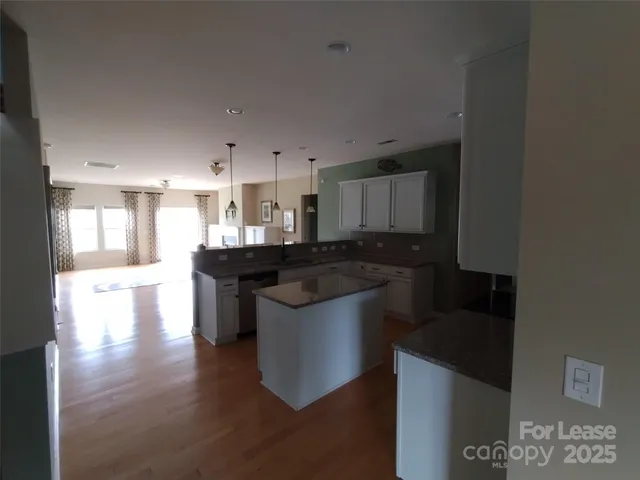 a kitchen with stainless steel appliances granite countertop a stove and a refrigerator