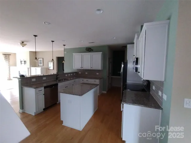 a kitchen with a sink stove and refrigerator