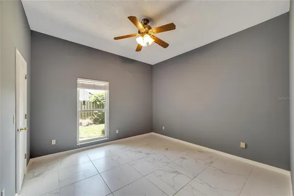 a view of a big room with closet and a ceiling fan