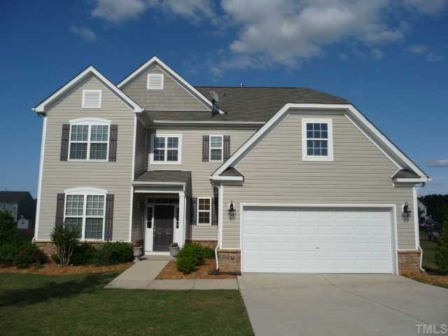 5208 Holly Ridge Farm Road Raleigh, NC 27616 - Photo 1 of 12 a front view of a house with a yard and garage