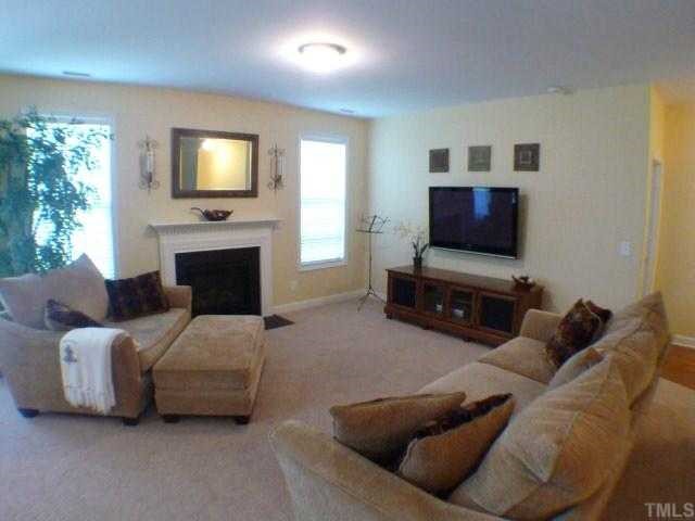 5208 Holly Ridge Farm Road Raleigh, NC 27616 - Photo 3 of 12 a living room with furniture and a flat screen tv