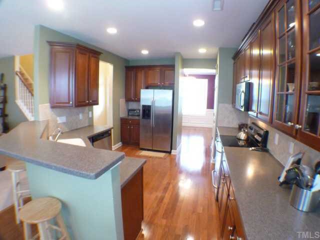 5208 Holly Ridge Farm Road Raleigh, NC 27616 - Photo 5 of 12 a kitchen with stainless steel appliances granite countertop a sink a stove and a refrigerator