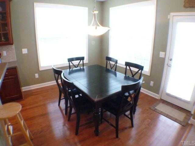 5208 Holly Ridge Farm Road Raleigh, NC 27616 - Photo 6 of 12 a view of a dining room with furniture and wooden floor