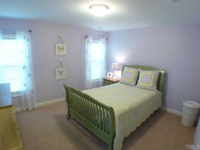 5208 Holly Ridge Farm Road Raleigh, NC 27616 - Photo 9 of 12 a bedroom with a bed and window