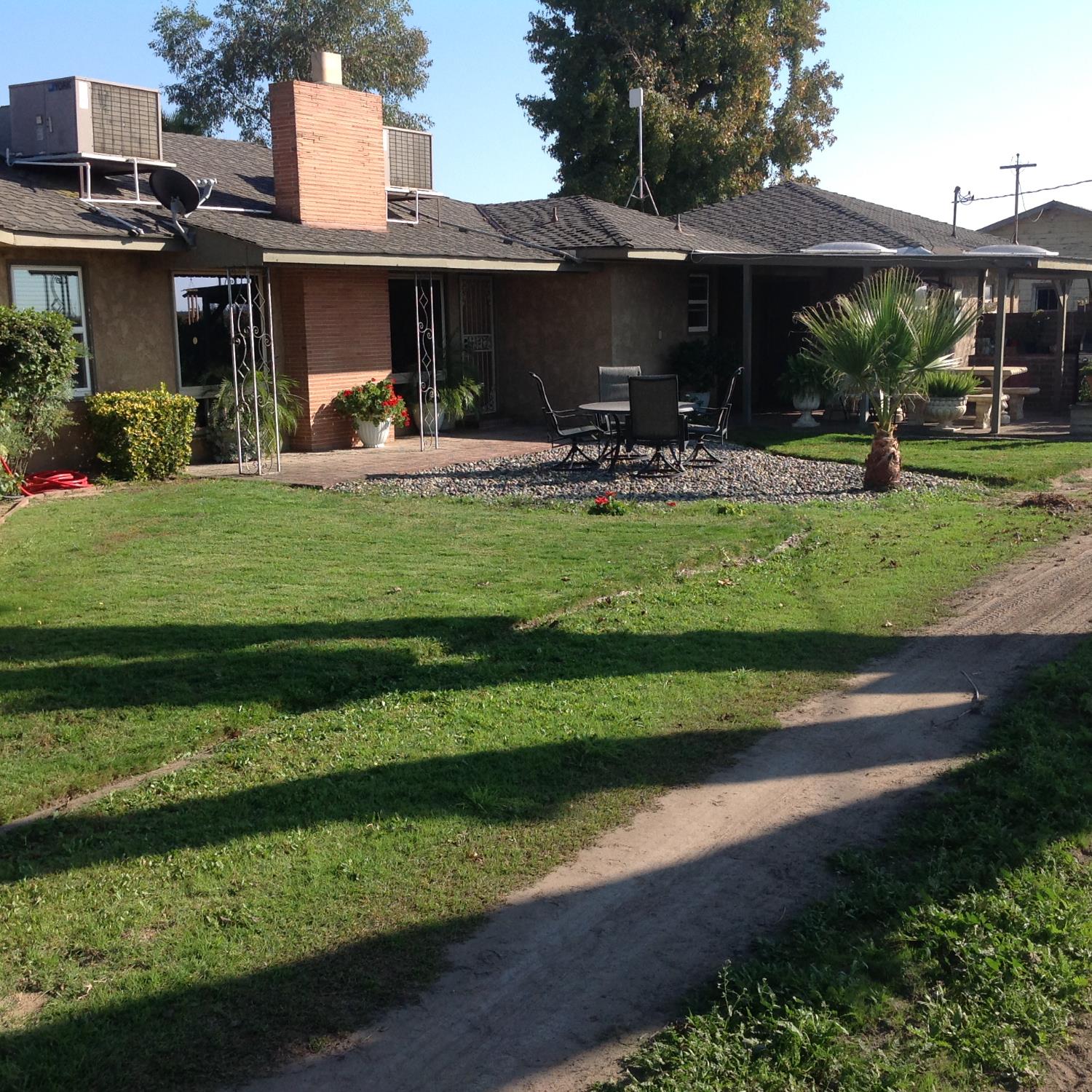 6623 East Nebraska Avenue Selma, CA 93662 - Photo 1 of 6 a view of a swimming pool with a table and chairs under an umbrella