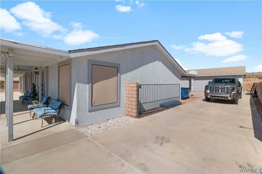 784 Pegasus Ranch Road Bullhead City, AZ 86429 - Photo 71 of 100 Light gray exterior with a covered porch and an attached garage