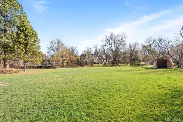 a view of outdoor space with green field and trees all around