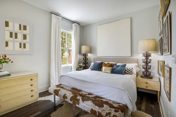 a bedroom with a bed and a window