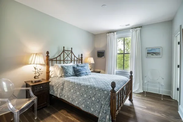 a bedroom with a bed a lamp and a window