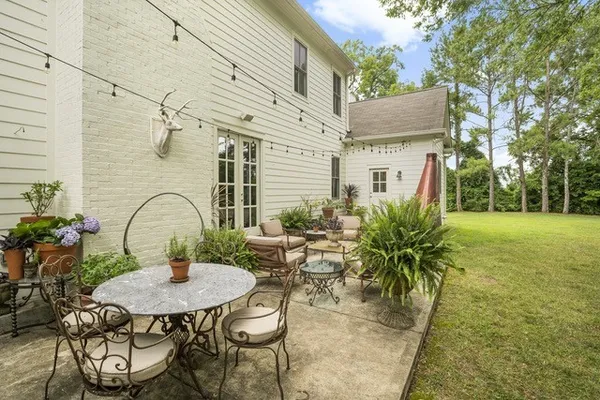 a view of a patio with table and chairs and potted plants