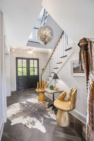 a view of a livingroom with furniture wooden floor and a chandelier