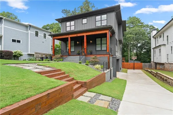 a front view of a house with a yard table and chairs