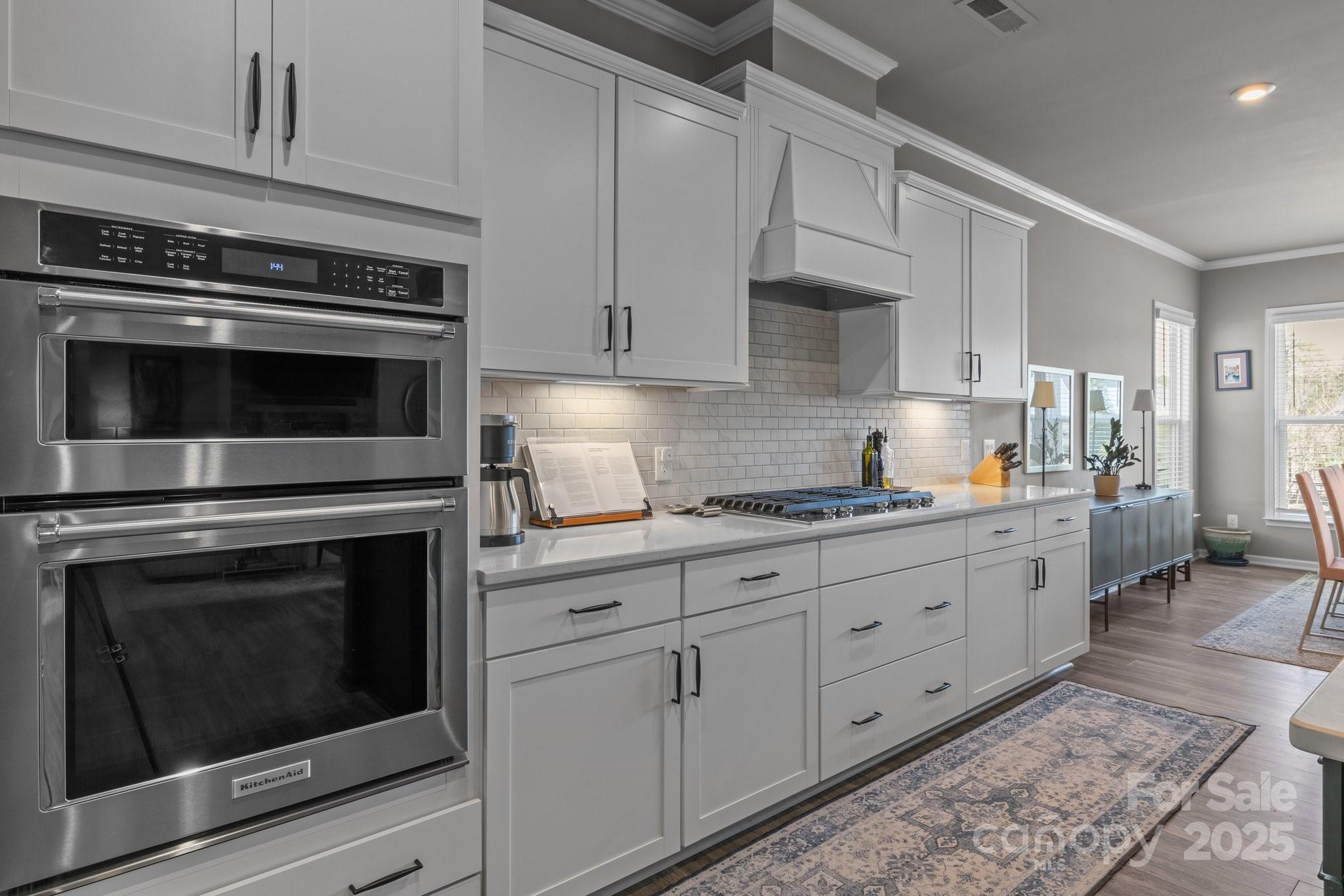 12709 Messenger Row Huntersville, NC 28078 - Photo 22 of 45 a kitchen with granite countertop white cabinets stainless steel appliances and sink