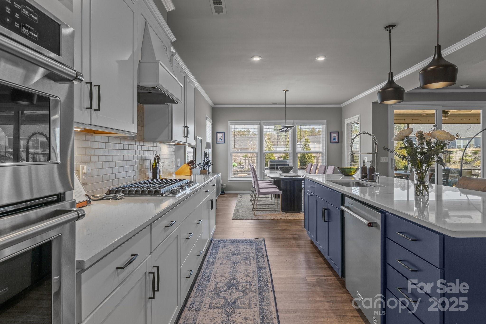 12709 Messenger Row Huntersville, NC 28078 - Photo 23 of 45 a large kitchen with stainless steel appliances granite countertop a stove and a sink