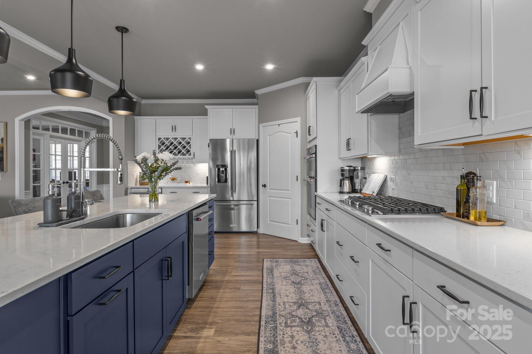 12709 Messenger Row Huntersville, NC 28078 - Photo 25 of 45 a large kitchen with stainless steel appliances lots of counter space and a sink
