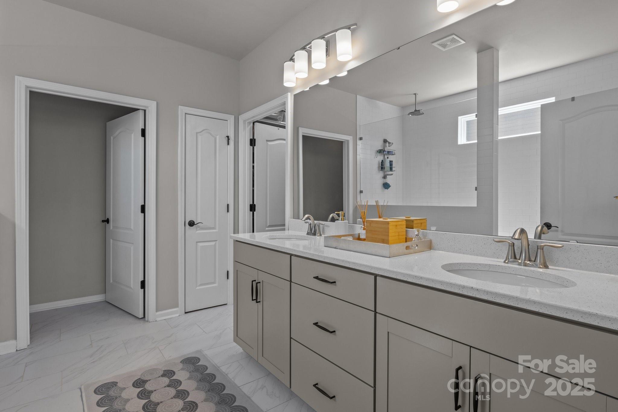 12709 Messenger Row Huntersville, NC 28078 - Photo 29 of 45 a bathroom with a double vanity sink and a mirror