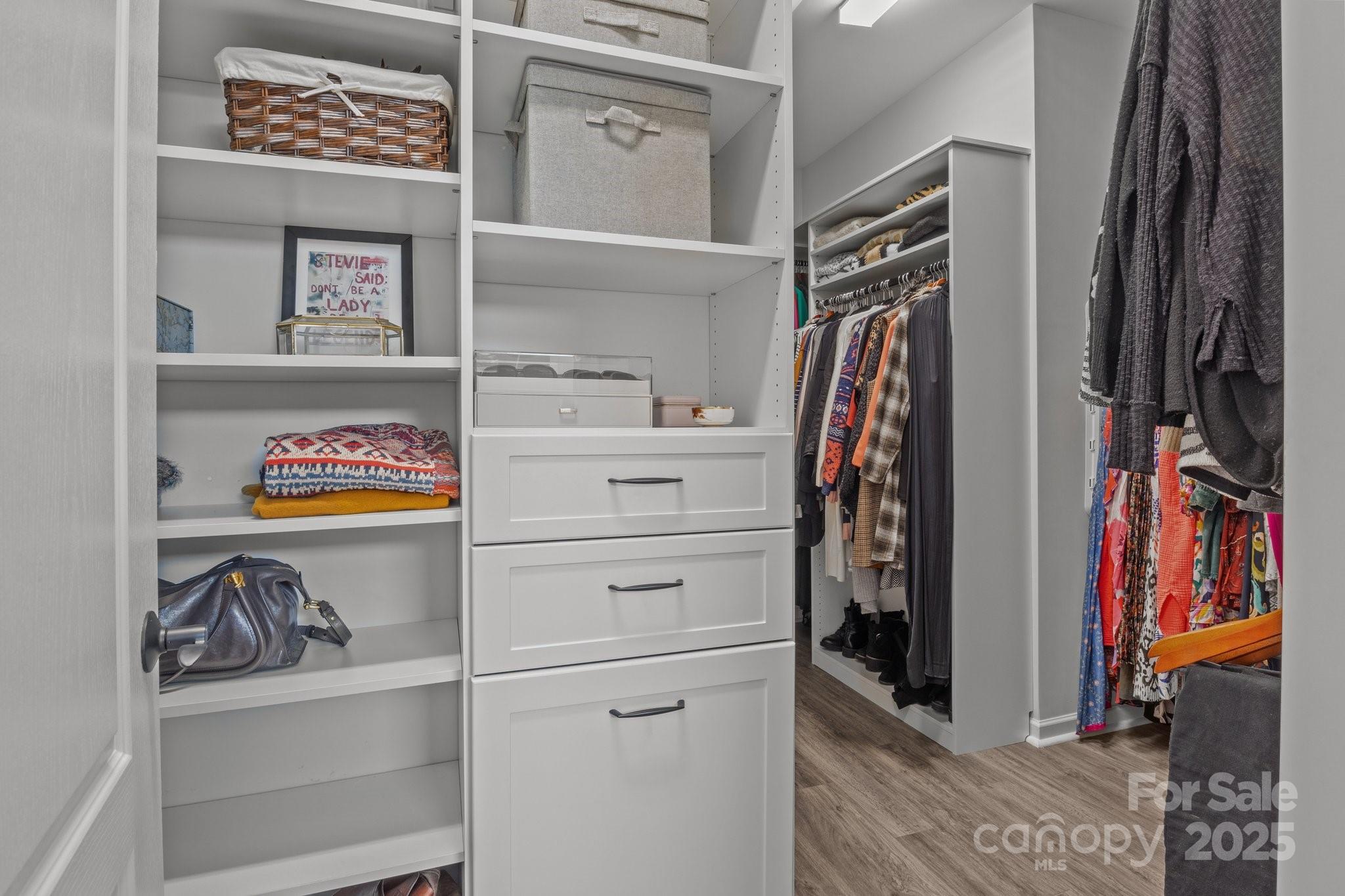 12709 Messenger Row Huntersville, NC 28078 - Photo 31 of 45 a view of walk in closet with clothes and shoes