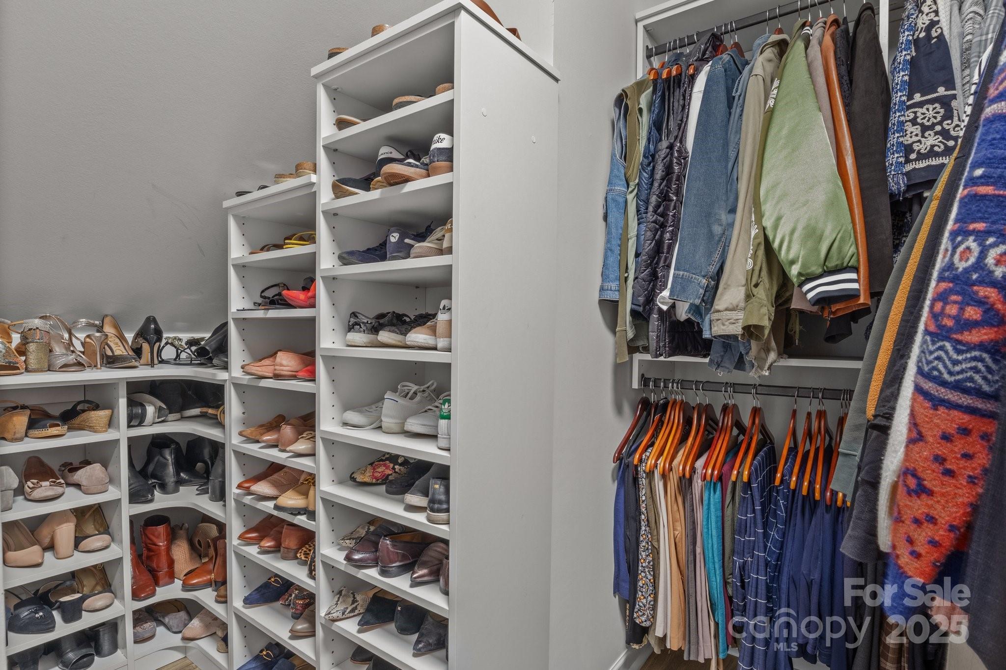 12709 Messenger Row Huntersville, NC 28078 - Photo 32 of 45 a view of walk in closet with clothes and shoes