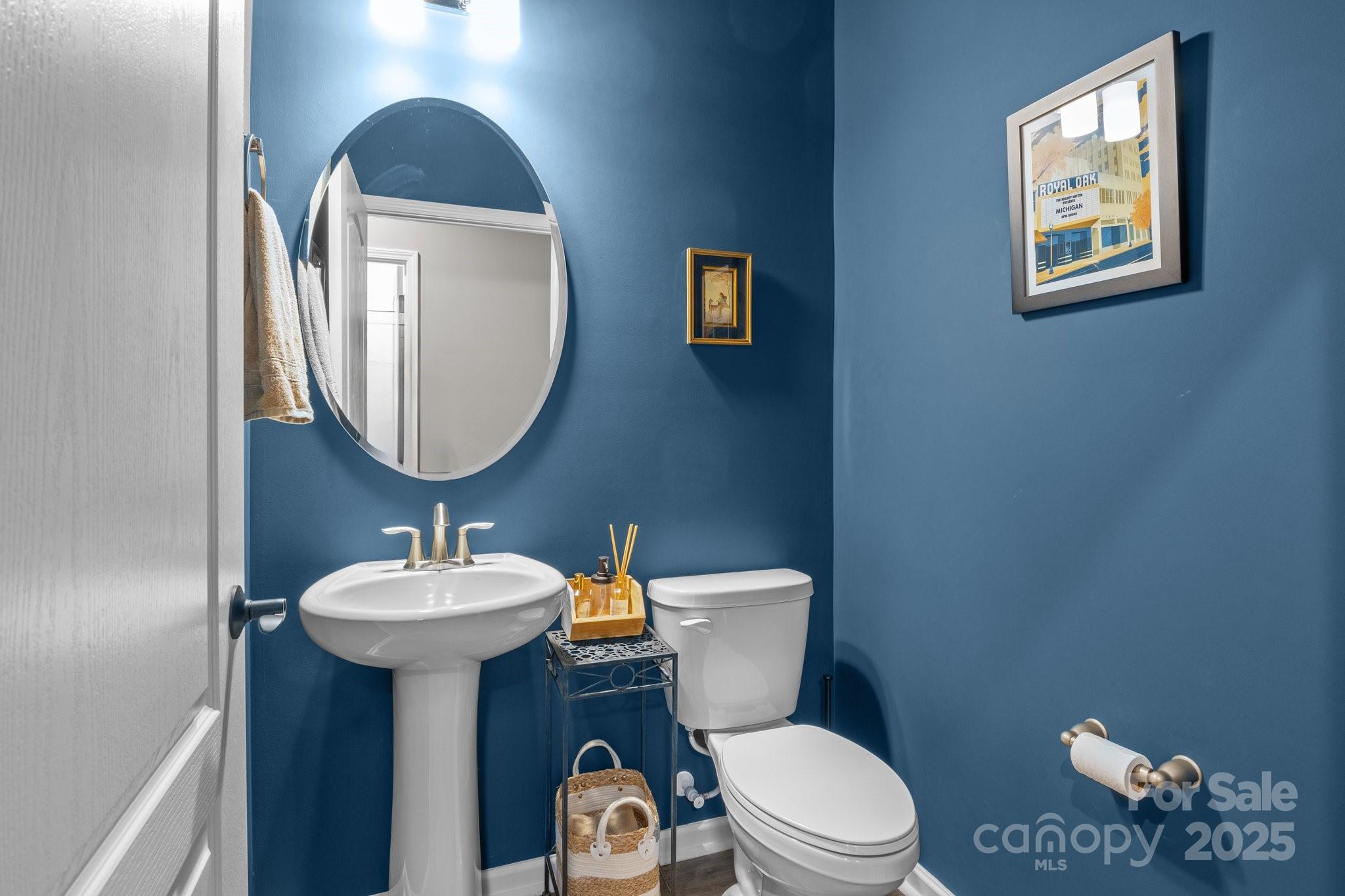 12709 Messenger Row Huntersville, NC 28078 - Photo 33 of 45 a bathroom with a toilet a sink and a mirror