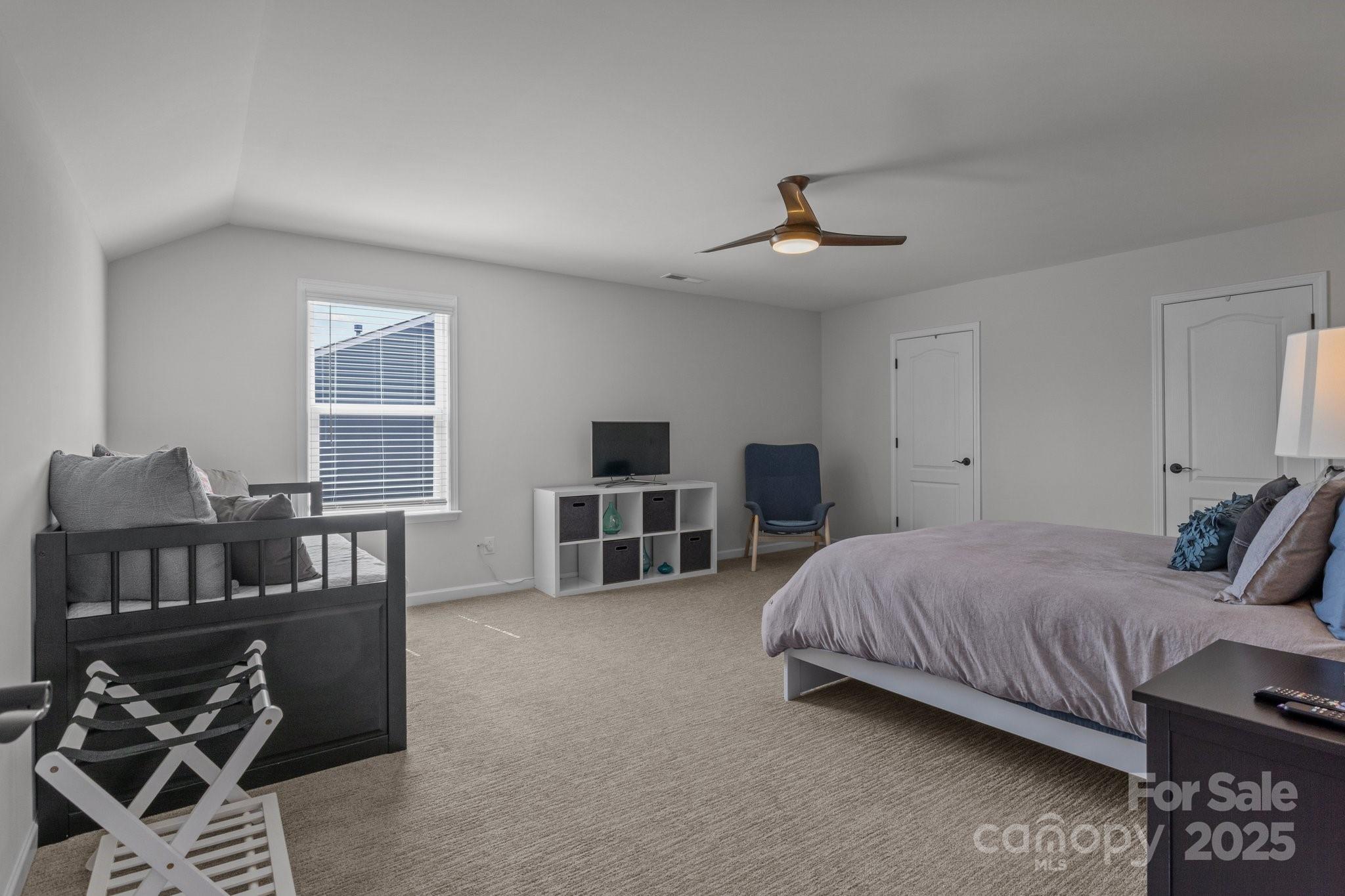 12709 Messenger Row Huntersville, NC 28078 - Photo 38 of 45 a bedroom with a bed furniture and a flat screen tv
