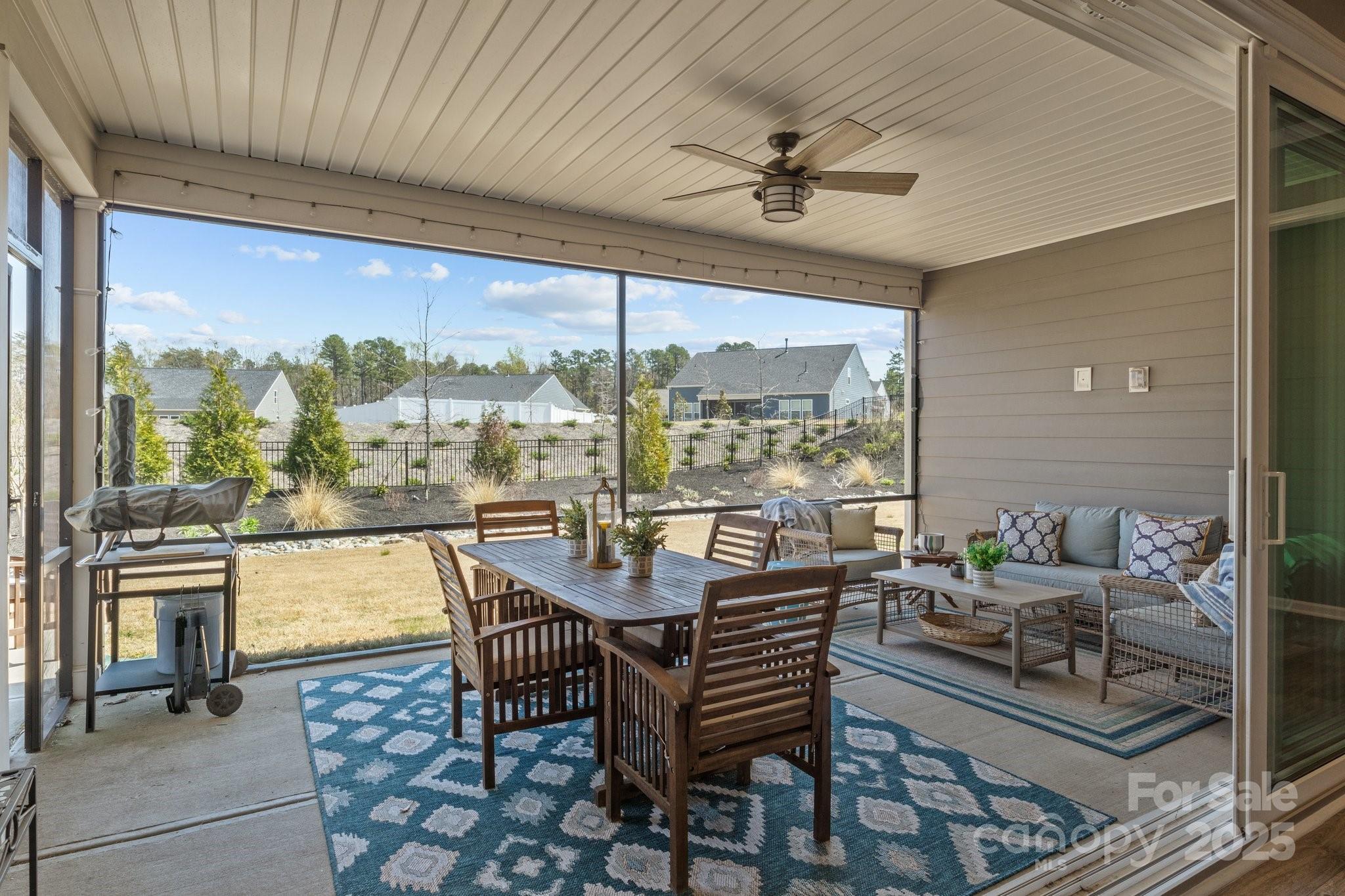 12709 Messenger Row Huntersville, NC 28078 - Photo 40 of 45 a dining room with furniture a floor to ceiling window and outdoor view