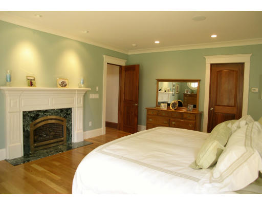 4 Robin Road Weston, MA 02493 - Photo 8 of 10 a spacious bedroom with a bed and a fireplace