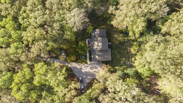 a view of a house with backyard water fountain and sitting area