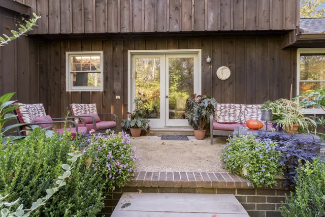 a backyard of a house with a yard and outdoor seating