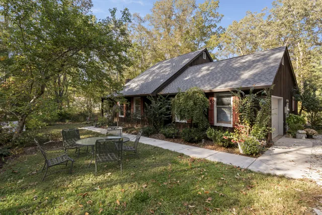 a view of flowing water with large trees