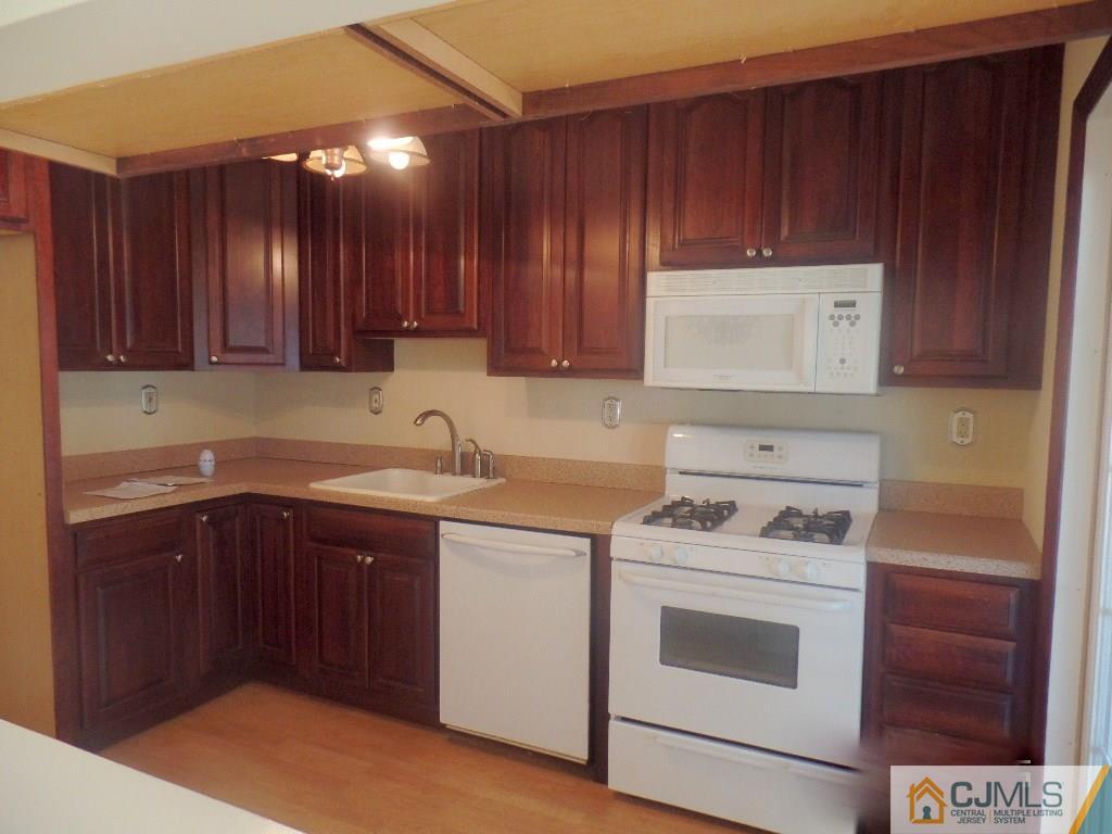 195 Midfield Road Colonia, NJ 07067 - Photo 2 of 21 a kitchen with a stove sink and cabinets