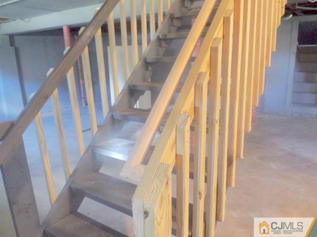 195 Midfield Road Colonia, NJ 07067 - Photo 13 of 21 a view of staircase with wooden floor and door